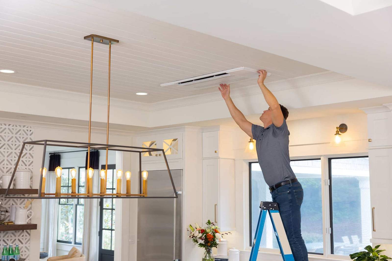 Superior CO-OP HVAC technician installing a Mitsubishi ceiling cassette